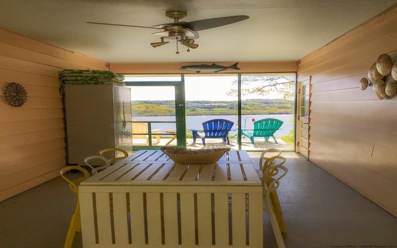 The screened breezeway is right off the kitchen and serves as a wonderful place to eat a meal.